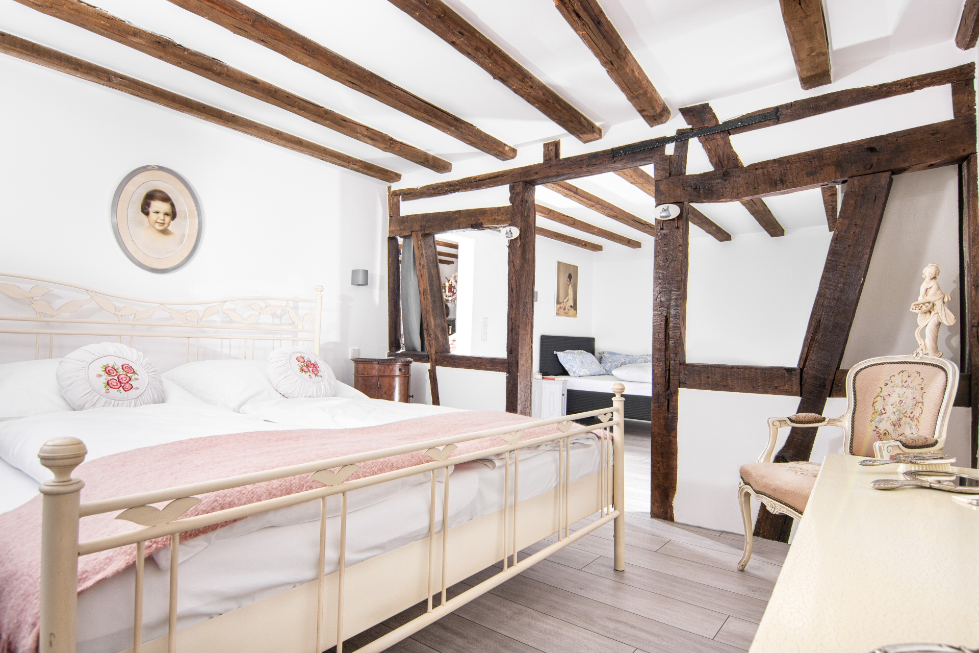 Schlafzimmer mit Blick durchs offene Fachwerk - Ferienwohnung Auszeit - Alte Uhrmacherei in Heimbach/Eifel